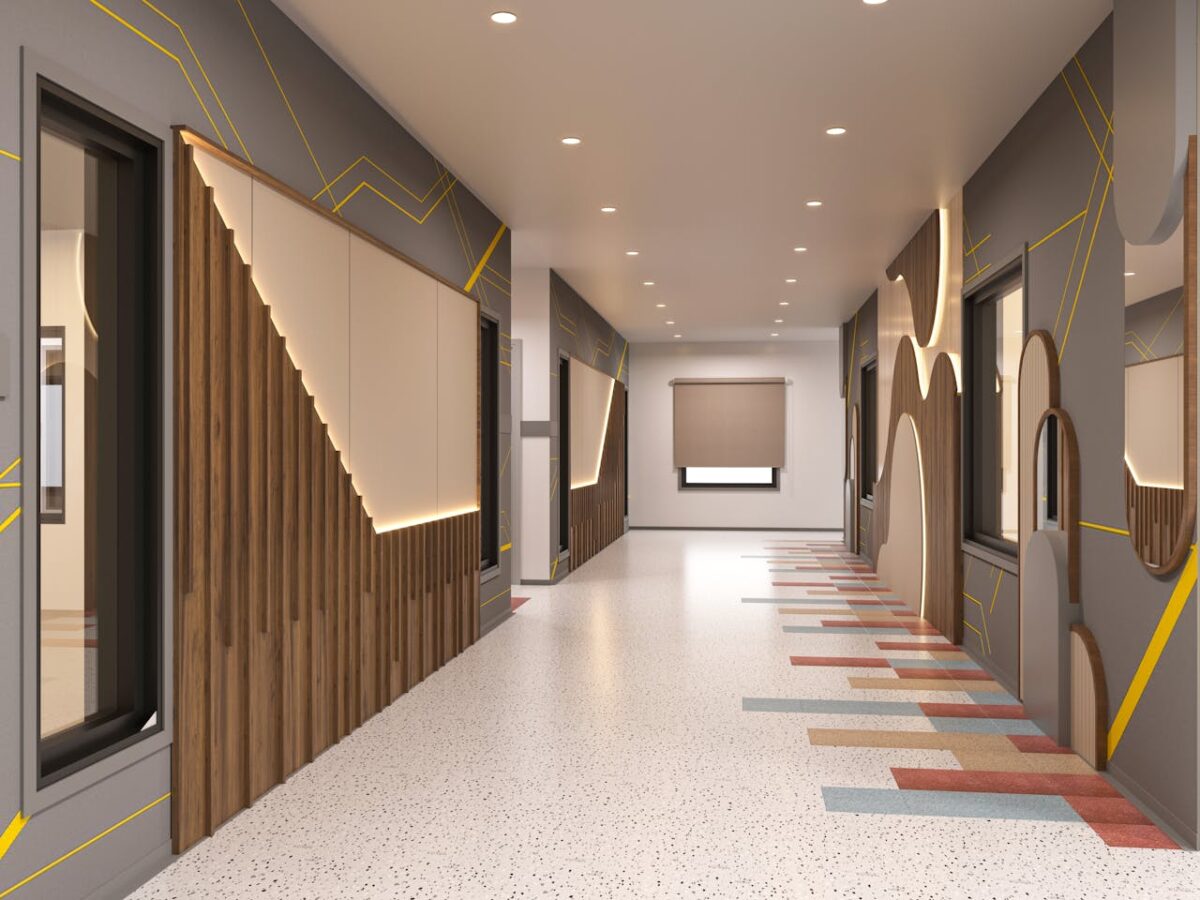 Sleek indoor corridor featuring contemporary geometric wall patterns and vibrant flooring.